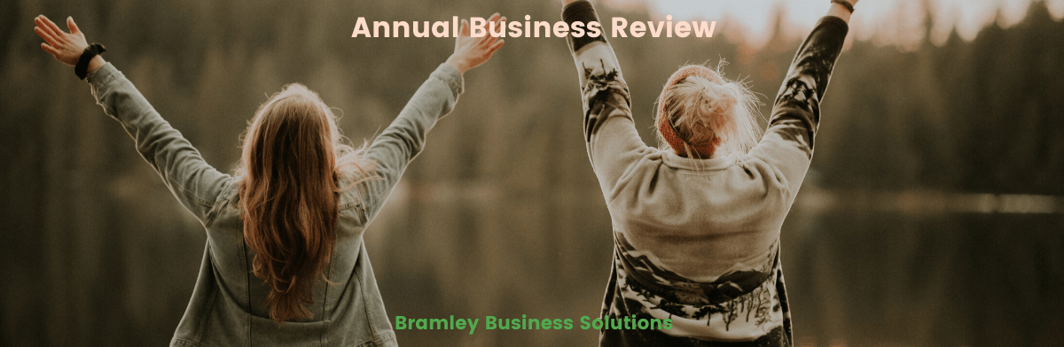 two women celebrating completing their annual business review outdoors