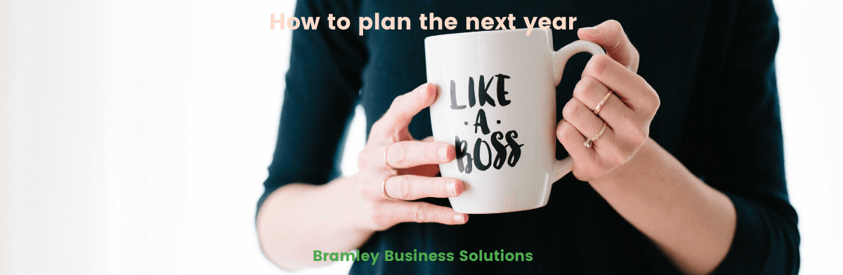 woman holding a mug with the words 'like a boss', title of the article across the top of the image 'how to plan the next year'