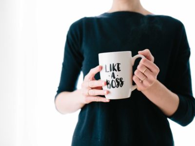 Like a boss mug Woman in black holding mug with the words 'like a boss' on it, while working on business solutions for small business
