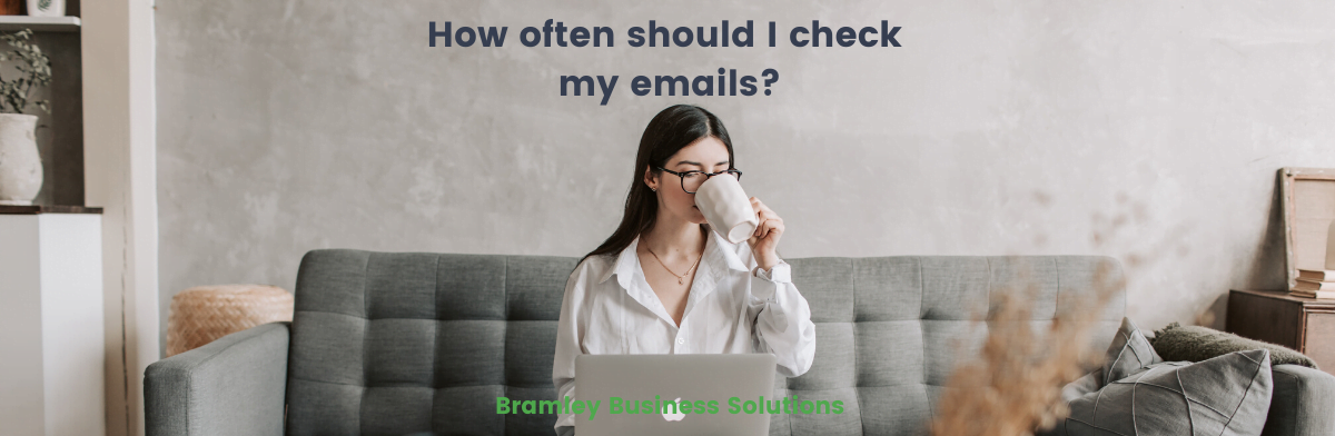 a woman on a sofa with a laptop and drinking from a mug, with the article title overlaid "How often should I check my emails?"